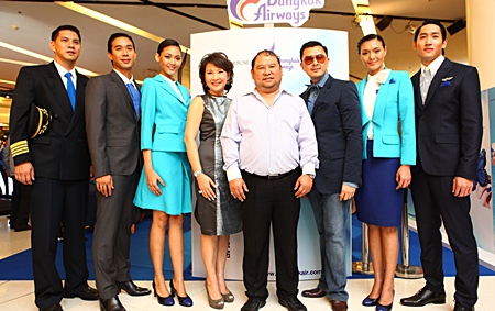 Management and staff show off the new uniforms.